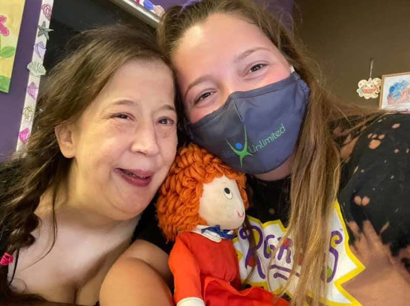 Two friends at Life Unlimited sharing a smile.