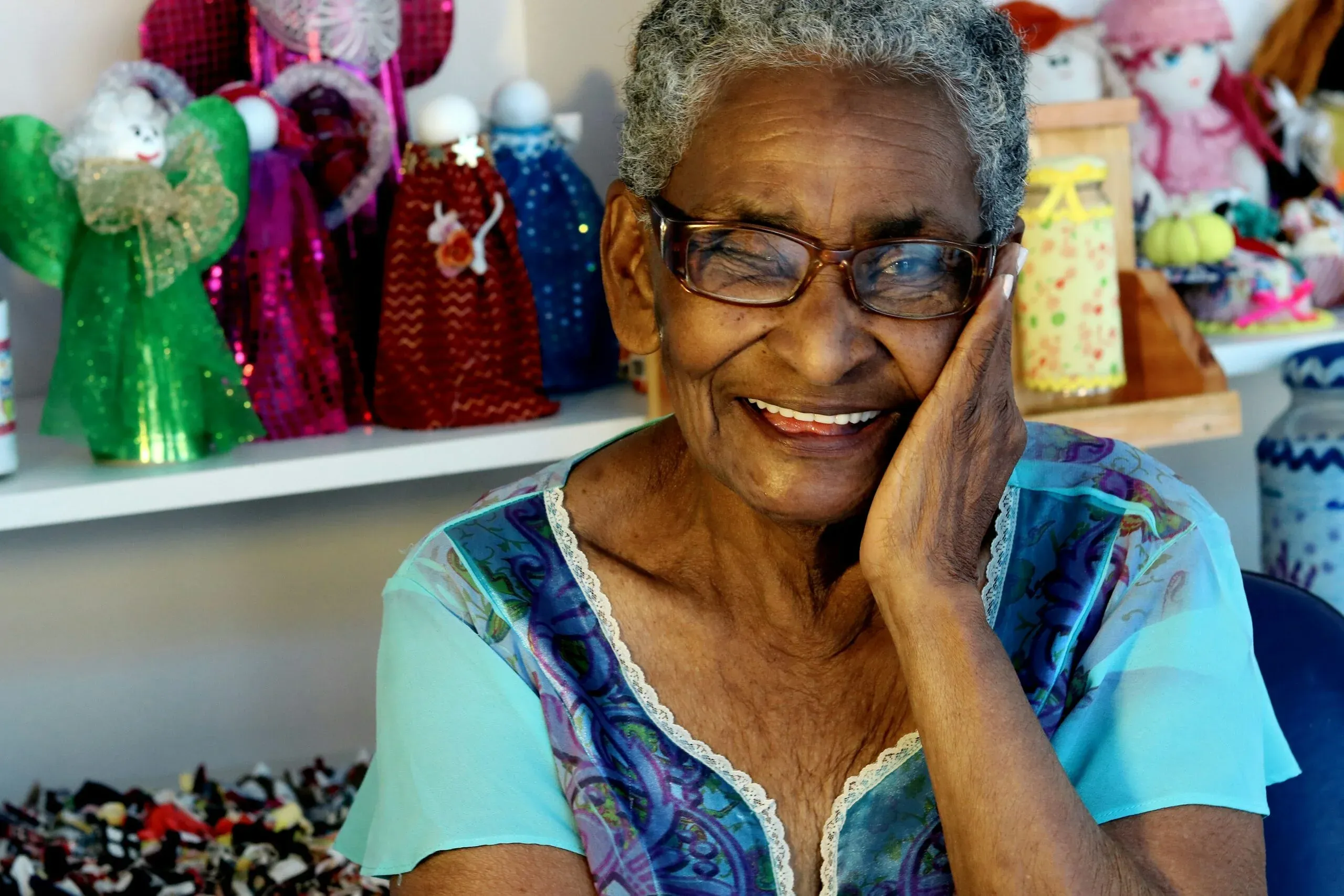 An elderly woman smiling.